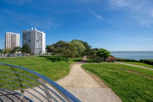 a path through a park with a view of the water at Nouveau - Horizons - Vue mer in Saint-Nazaire
