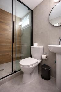 a bathroom with a toilet and a sink and a shower at Top Location Studios - Avra, Boreio and Kyma in Larnaca +18 photos