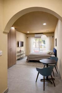 a bedroom with a bed and a table at Top Location Studios - Avra, Boreio and Kyma in Larnaca