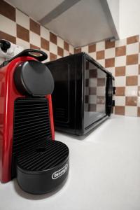 a microwave sitting on top of a kitchen counter at Top Location Studios - Avra, Boreio and Kyma in Larnaca