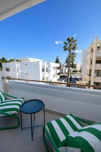 a balcony with two chairs and a view of a city at Top Location Studios - Avra, Boreio and Kyma in Larnaca