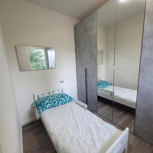 a bedroom with two beds and a mirror at Garden Relais Mountain Lake Iseo Hospitality in Solto Collina +22 photos