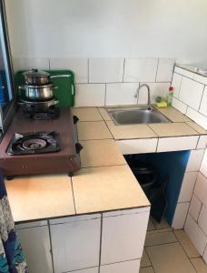 a small kitchen with a stove and a sink at OCEAN-SI Mansion in Kribi