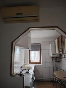 a small kitchen with a sink and a window at Apartament in Geoagiu Băi +5 photos