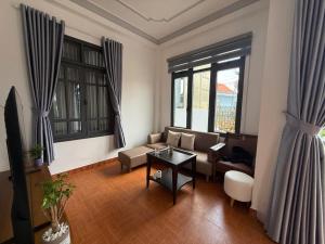 a living room with a couch and a table at Mây's Villa in Da Lat