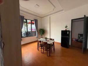 a dining room with a table and chairs in a room at Mây's Villa in Da Lat