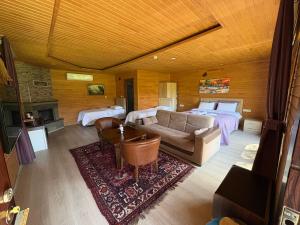 a living room with a couch and a bed at pınar kır evi in Artvin