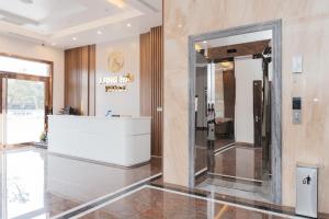 a lobby of a hotel with a mirror at Long Hải Hotel in Móng Cái