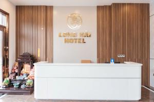 a hotel lobby with a white reception desk at Long Hải Hotel in Móng Cái
