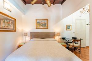 a bedroom with a large bed and a desk at Guest House Villa Verde - Short Term Room Rentals in Torre delle Stelle +119 photos