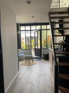 a room with a staircase and a living room at L'atelier Maillot in Évreux