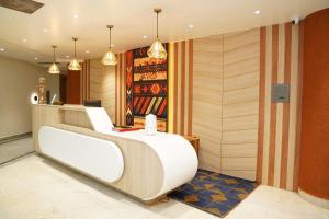 a wine tasting room with a white bed and a wine rack at Hotel Kama, Patna in Patna