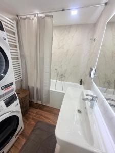 a white bathroom with a sink and a microwave at Новый Хостел с Кабинками in Chişinău