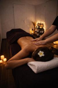 a woman laying on a bed getting a massage at Maison avec Jacuzzi Privatif Calme Soleil Cote d Azur in La Crau