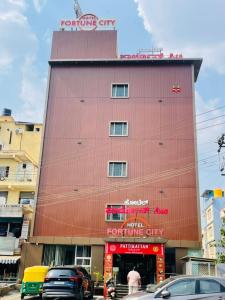 a red building with a sign on top of it at hotel fortune city in Bangalore