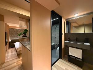 a small bathroom with a sink and a toilet at Hatagoyorozu in Sasebo