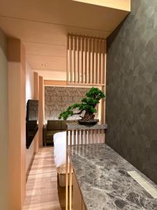 a kitchen with a counter with a plant on top of it at Hatagoyorozu in Sasebo +27 photos