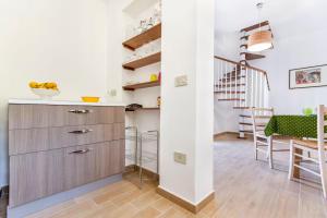 a kitchen with a counter and a dining room at Casa Normanna in Palermo