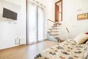 a living room with a bed and a television at Casa Normanna in Palermo