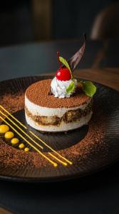 a chocolate cake with a cherry on top on a plate at Samann Blue in Hulhumale