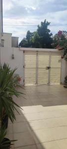a garage with two large doors on the side of it at Maison du Bonheur in Ariana