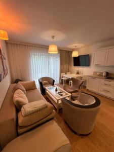 a living room with a couch and a table at Głębinów Apartamenty nad jeziorem nyskim in Głębinów