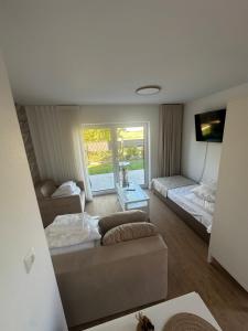 a living room with a couch and a bed at Głębinów Apartamenty nad jeziorem nyskim in Głębinów