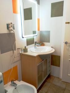 a bathroom with a sink and a mirror and a toilet at Apartamento limonero ,VUT AL 13044 in Albox +10 photos