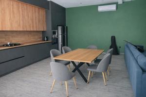 a kitchen with a table and chairs and a couch at Villa in Mayak in Baku