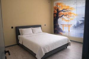 a bedroom with a bed with a large painting on the wall at Villa in Mayak in Baku +9 photos