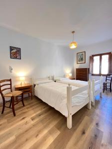 a bedroom with two beds and a table and chairs at Locanda dei Gelsomini in Civitella Del Lago +34 photos