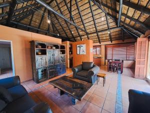 a living room with a couch and a table at Greenfields Guesthouse & Restaurant in Alberton