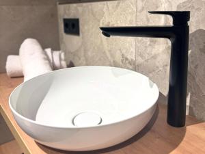 a white bowl sink sitting on a counter in a bathroom at Schuhbauers Oberwirt - digitale Self-Check-in Apartments in Schnotting