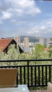 a balcony with a view of a city at Behar Apartment with City View in Sarajevo
