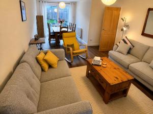 a living room with a couch and a coffee table at Westbrook Spacious 3 Bed in Exeter in Pinhoe