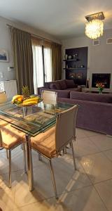 a dining table and chairs in a living room at The Beach House in Porto Rafti