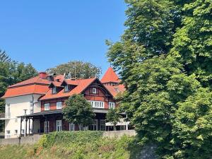 a large house with a red roof on a hill at Harmonija26 in Karlovac