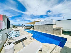 a swimming pool on the roof of a house at Prime CBD High Rise Apartment in Cairns
