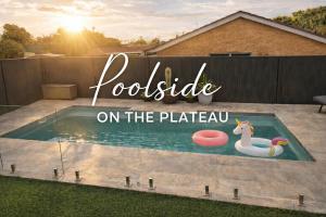 a poolside on the plateau sign in a backyard at Poolside on the Plateau in Wollongbar