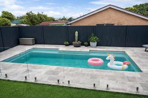 a swimming pool with a unicorn toy and a frisbee at Poolside on the Plateau in Wollongbar