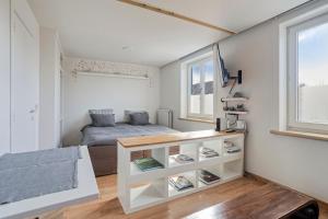 a small bedroom with a bed and a desk at SleutelVan8 in Knokke-Heist