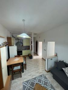 a living room and kitchen with a table and a couch at Casa Bice in Misano Adriatico