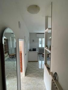 a living room with a mirror and a kitchen at Casa Bice in Misano Adriatico