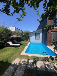 a swimming pool in the backyard of a house at Villa Rüzgar in Dalaman