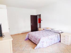 a bedroom with a bed and a dresser at Levico Centrale Apartment in Levico Terme