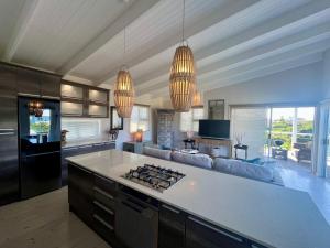 a kitchen with a stove top oven in a room at The Blue Dragonfly in Jeffreys Bay