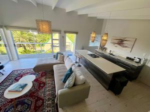 a large living room with a couch and a table at The Blue Dragonfly in Jeffreys Bay +15 photos