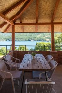 a wooden table and chairs on a patio at Apartmani Maja in Rastište