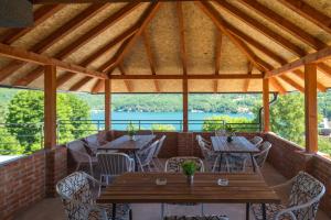 a patio with tables and chairs on a brick wall at Apartmani Maja in Rastište +116 photos