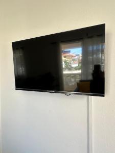 a flat screen tv hanging on a wall at las gaviotas in Bayahibe
